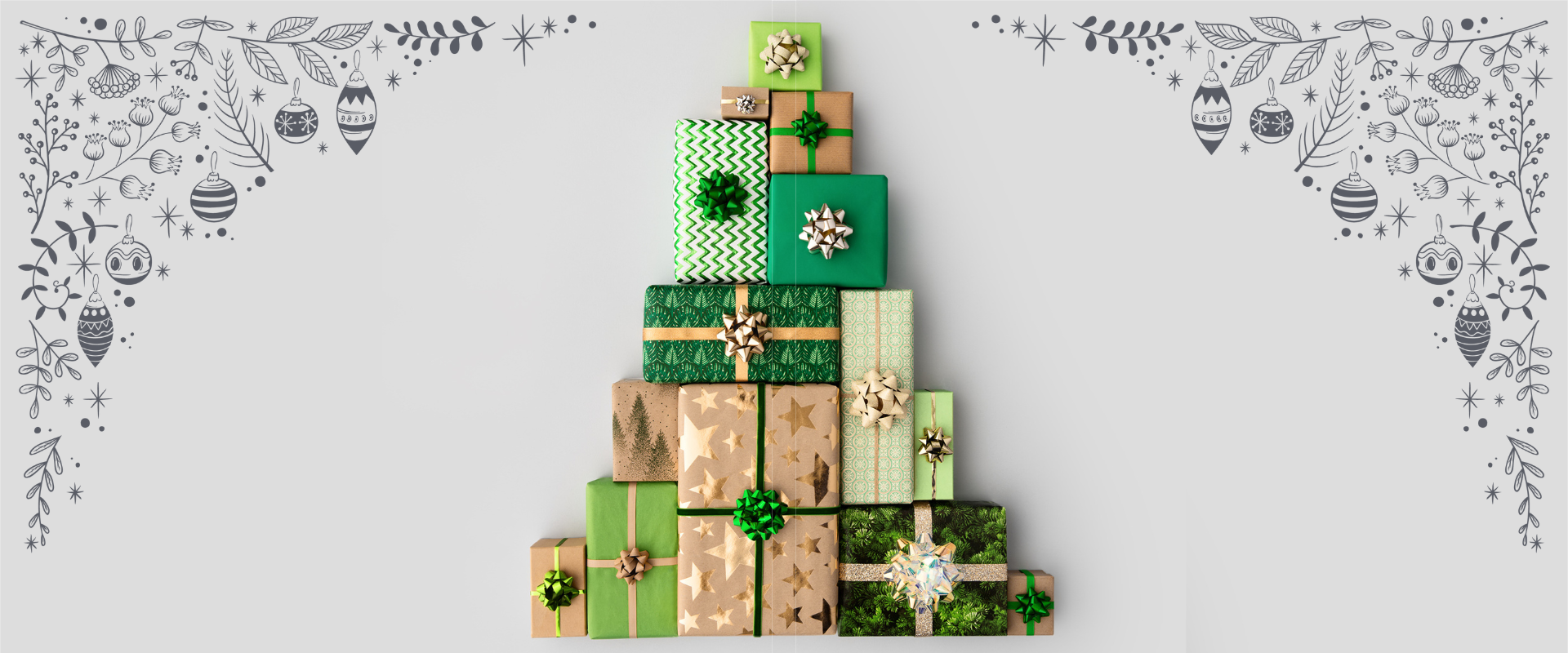 Christmas gifts shaped as a christmas tree on a grey background